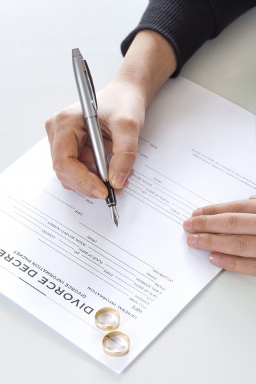 A man who forged his sick wife's signature on divorce papers has been jailed