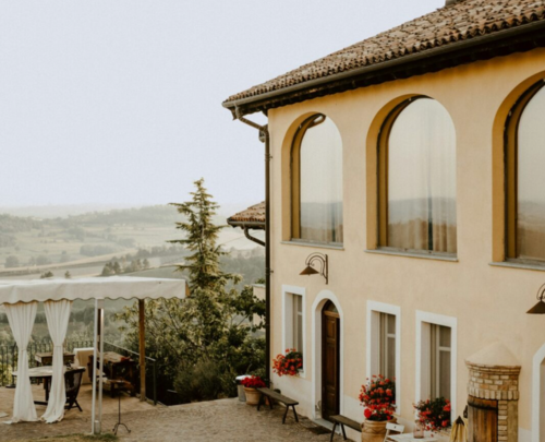 Close up of a woman signing a Vardags letter, on a dark wooden desk